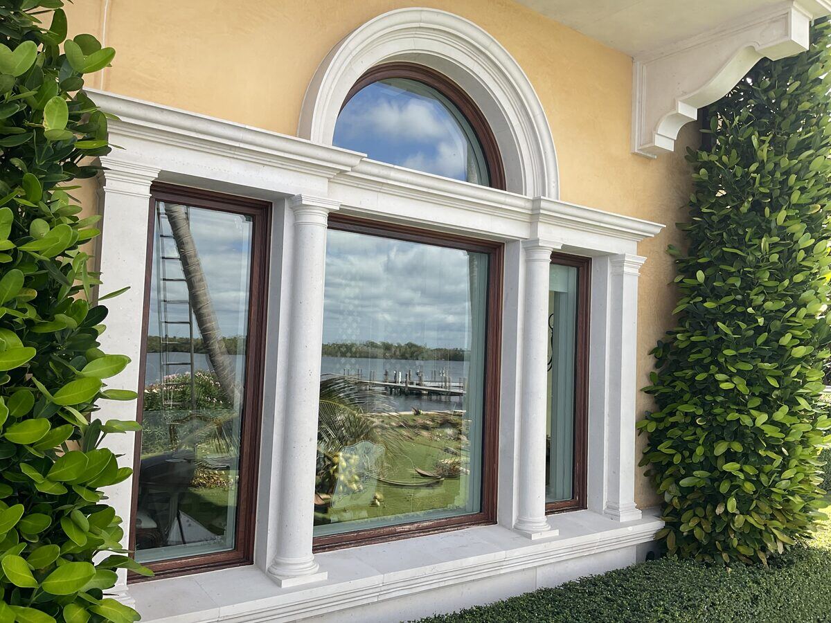 Arched estate window with limestone trim
